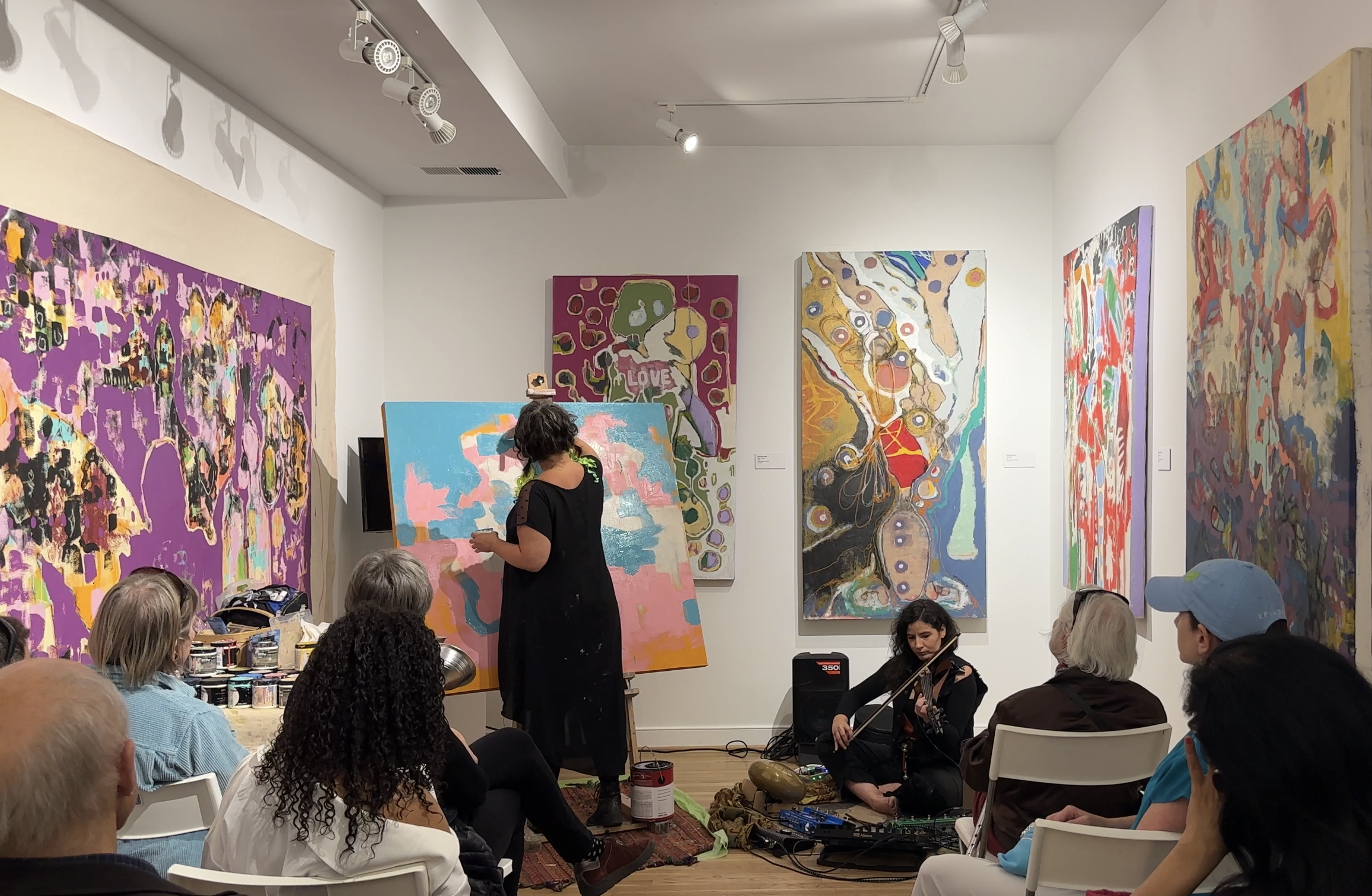 Past exhibiting solo artist Zhenya Parrish live painting to a musical performance